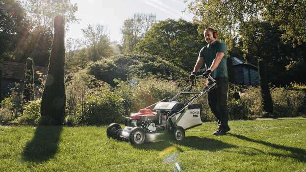 Man Pushing Honda HRH In Garden