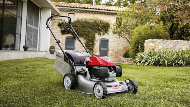 Side view of IZY lawnmower in garden